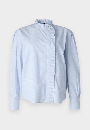 Blouse rayée bleu clair avec des manches longues, un col volanté et une fermeture à boutons. Fabriquée en tissu doux avec une coupe décontractée et une fente sur les côtés.