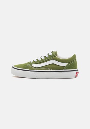 Green canvas sneaker with white laces and side stripe, featuring a white midsole and black outsole with red heel accent.