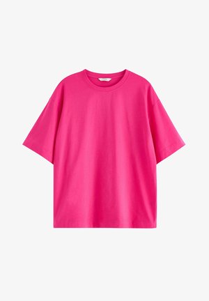 T-shirt in cotone rosa con maniche corte, scollo rotondo e vestibilità rilassata. Texture liscia senza motivi o accenti visibili.
