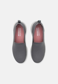 Gray slip-on shoes with a textured mesh upper and pink insoles. Features a lightweight outsole and a loop for easy wearing.