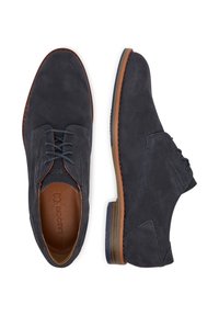 Ciemnoniebieskie zamszowe buty o gładkiej fakturze. Posiadają brązową skórzaną wkładkę i kontrastujące przeszycia. Sznurowany fason z zaokrąglonym czubkiem.