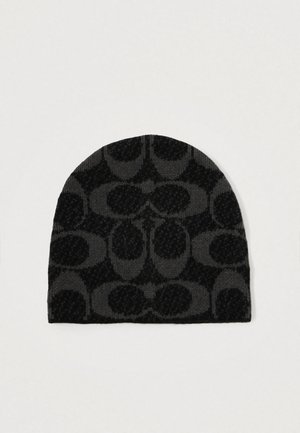 Bonnet en tricot noir avec un motif texturé comportant des demi-cercles superposés. Tissu lisse avec un dessus arrondi et un ajustement serré.