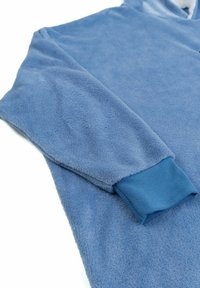 Garment in pile blu con una superficie texturizzata, maniche lunghe e polsini a costine di una tonalità blu più scura. Materiale liscio e morbido.