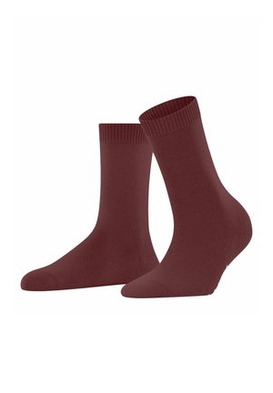 Une paire de chaussettes unies couleur bordeaux avec des poignets côtelés, présentée sur un fond blanc.