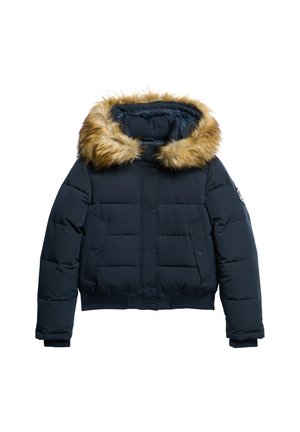 Navy blue puffer jacket with a fur-trimmed hood, featuring a structured design, snap-button closure, and two front pockets.
