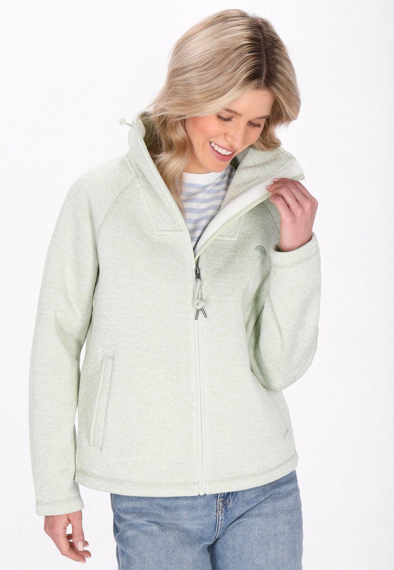 Giacca in fleece verde chiaro con colletto alto, chiusura con zip frontale e due tasche laterali. Presenta un motivo testurizzato e polsini elasticizzati.