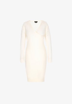 Rochie tricotată albă cu decolteu în V, mâneci lungi și umeri embellisati cu mici mărgele. Design ajustat care se îngustează până la mijlocul coapsei.
