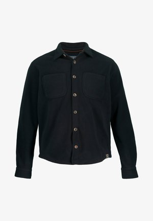 Camisa de franela negra con botones, con dos bolsillos frontales, costuras visibles y un dobladillo recto. Presenta un cuello clásico y una tapeta de botones.