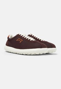 Burgundy athletic shoes with a smooth textile upper, white laces, contrasting brown accent near the heel, and cushioned rubber sole.