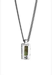 Sterling silver necklace featuring a rectangular pendant with a textured surface and a green stone encased within. 925 Ag hallmark included.