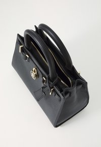 Sort læderhandbag med to korte håndtag, guldlås, lynlåslukning og struktureret finish. Har et logo-tryk på forsiden.