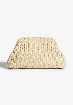 Austi kreminės spalvos krepšys su faktūruota paviršiaus tekstūra, apvaliu siluetu ir plačia baze. Medžiaga atrodo tvirta ir lanksti.