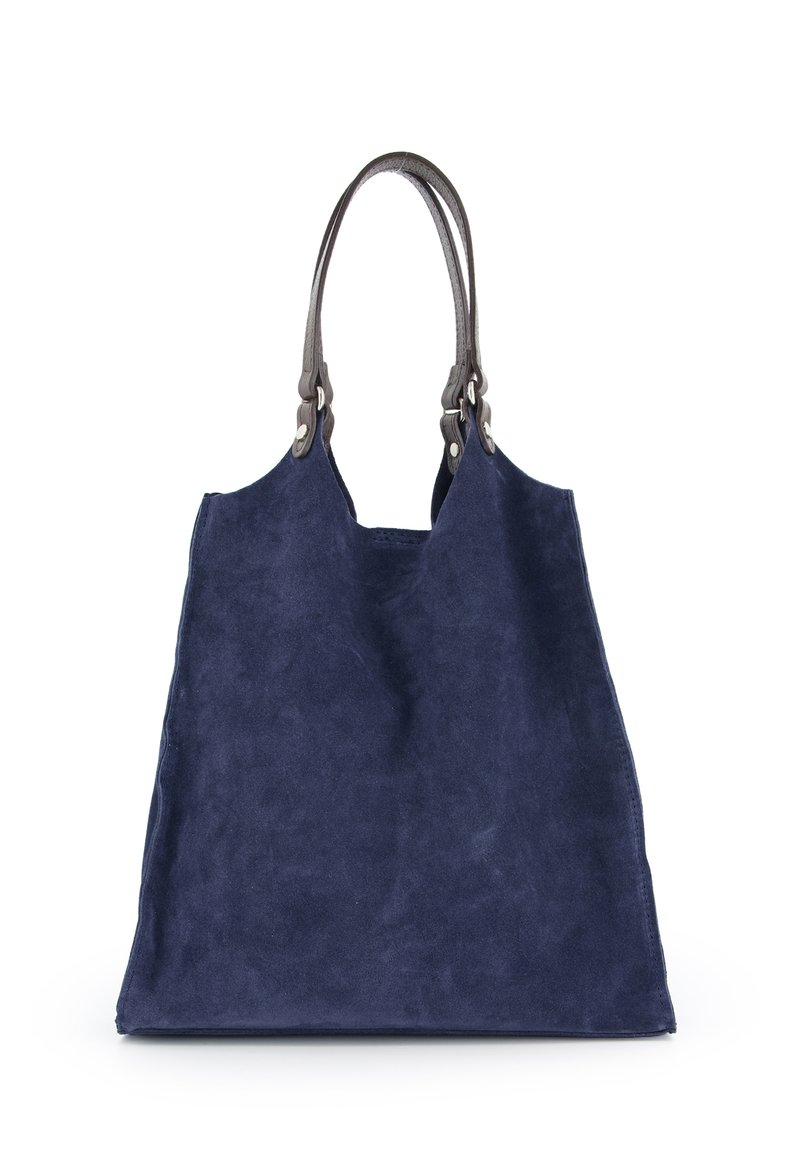Marineblå mokkabags med rummelig form, glat tekstur og brune læderhåndtag med metalhardware-detaljer.