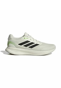 Zapatilla deportiva con una parte superior de malla gris claro, rayas negras, un acento verde en el talón y suela blanca texturizada con tecnología Cloudfoam.