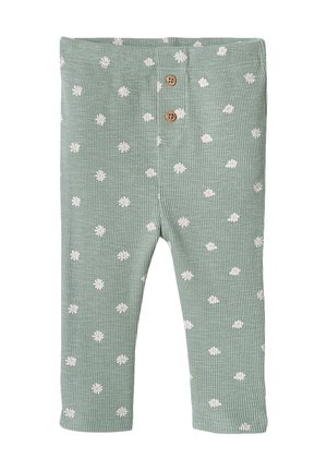 Green ribbed baby leggings with white daisy patterns and two brown buttons at the waistband.
