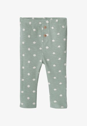 Green ribbed baby leggings with white daisy patterns and two brown buttons at the waistband.