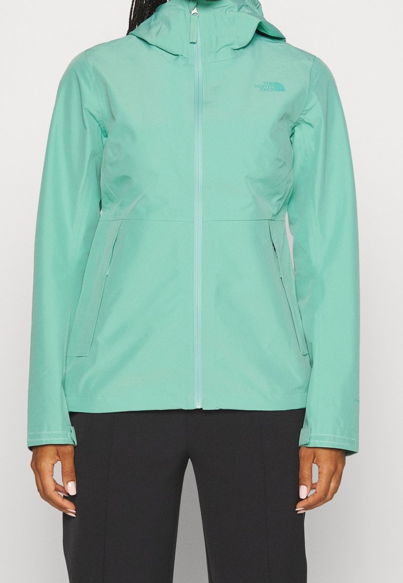 Lätt, mintgrön vattentät jacka med huva, dragkedja och sidofickor, med en slät yta och minimal märkning.