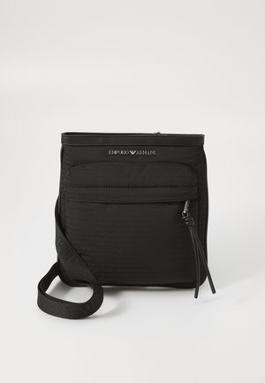 Black Emporio Armani crossbody bag with front zipper pocket, adjustable strap, and logo detail on textured fabric.