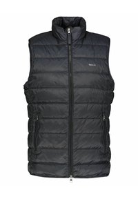 Zwarte gewatteerde vest met hoge kraag, rits aan de voorkant en twee zijzakken. Heeft een gestikte textuur en een logo-detail op de borst.