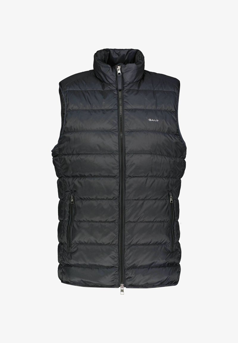 Black padded vest with a high collar, front zip closure, and two side pockets. Features quilted texture and logo detail on the chest.