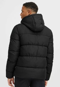 Black puffer jacket with a hood, featuring horizontal quilted sections, smooth fabric texture, and elastic cuffs for a snug fit.