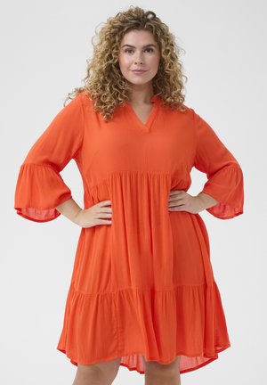 Short-sleeved, v-neck, knee-length dress in bright orange fabric with a textured finish and tiered hem. Features loose, flared sleeves.