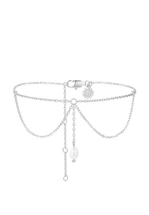 Delicate silver chain bracelet with a small clasp, a smiling sun charm, and a central white pearl hanging from the chain.