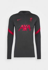 Grå langærmet sports T-shirt med sorte teksturerede mønstrede ærmer. Har en kvart lynlås, røde accentfarver og "AXA" logoet på fronten.