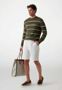 Olive striped sweater, white linen shorts, brown loafers, and a gray tote bag with brown leather accents. Simple and casual outfit design.