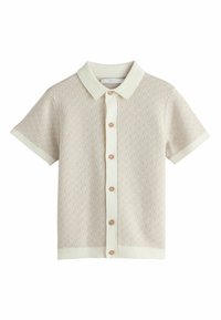 Short-sleeve, light beige polo shirt with a textured pattern, cream collar and cuffs, and rose gold buttons down the front.