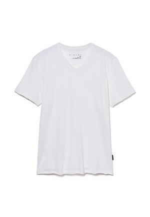 T-shirt blanc à manches courtes en V en 100 % coton bio. Texture douce avec une coupe droite et un branding minimal sur le bas.