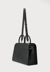Μαύρη δερμάτινη τσάντα χειρός με δύο κοντές χειρολαβές, μακρύ ρυθμιζόμενο ιμάντα ώμου και πλαϊνή τσέπη με φερμουάρ.