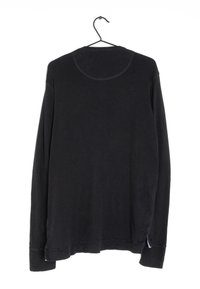 Long-sleeve black cotton shirt on a hanger, featuring a crew neck, straight hem, and side slits at the bottom edge.