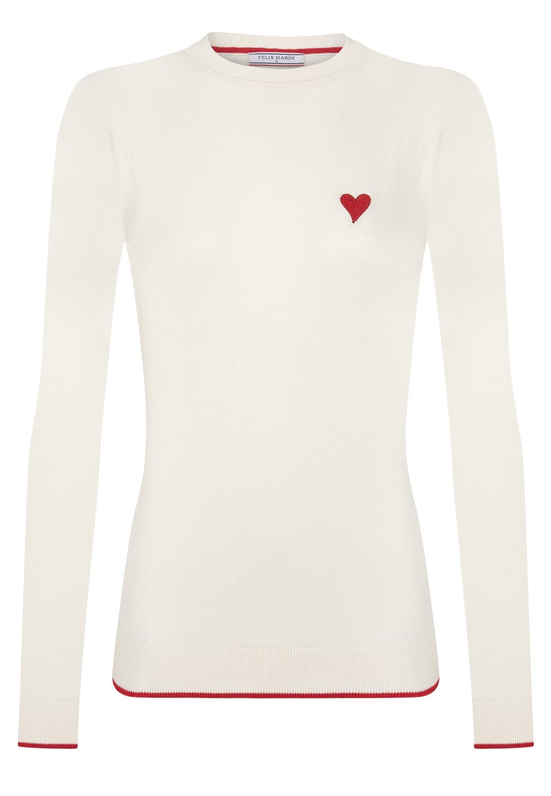 Biały sweter z długim rękawem z małym haftowanym czerwonym serduszkiem na piersi, czerwonymi paskami na mankietach i u dołu. Miękka dziana tkanina.
