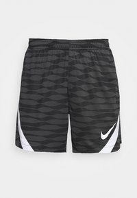 Nike träningsshorts i svart med grå vågigt mönster, elastisk midjeband och vit logga på sidan. Lättviktigt tyg med en mjuk textur.