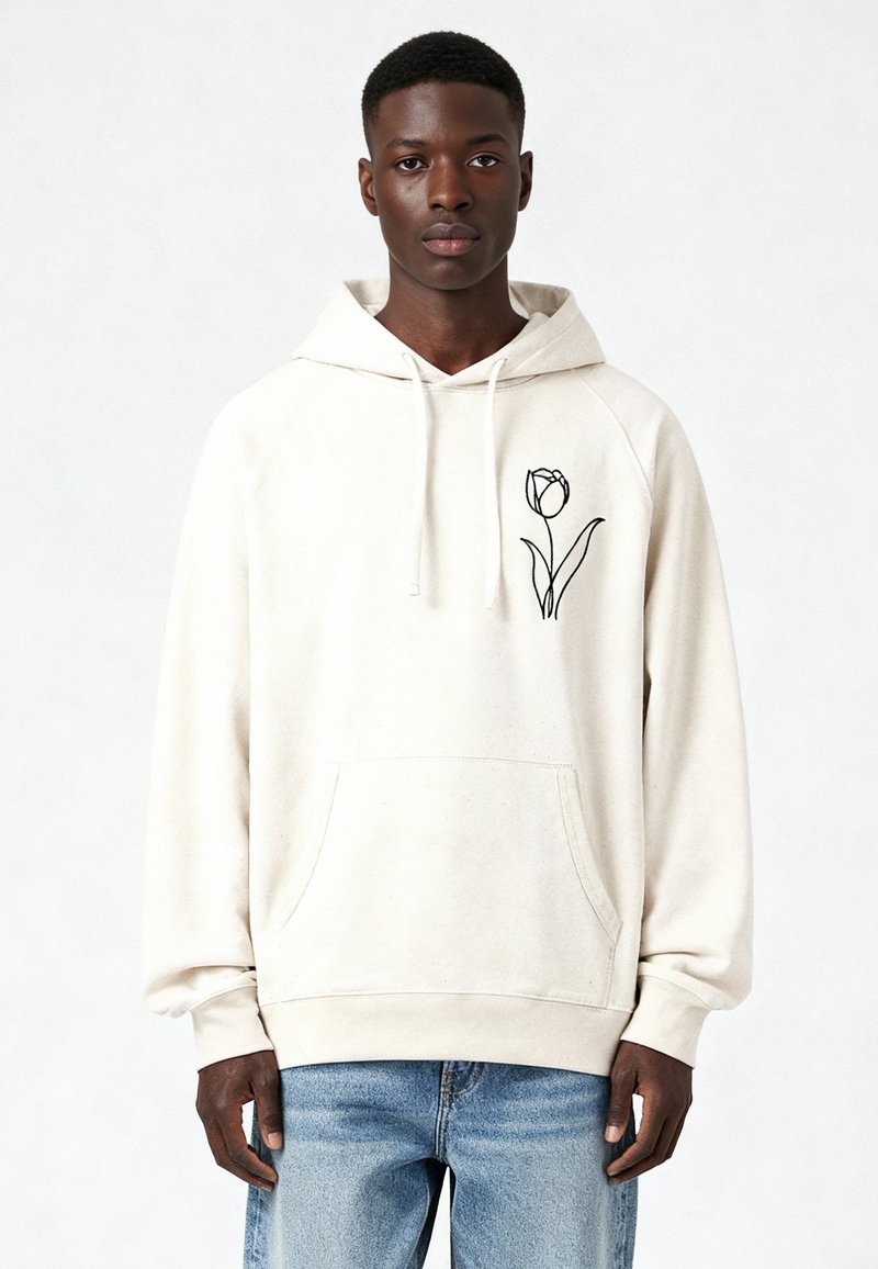 Sweat à capuche beige clair en tissu doux, avec un motif de tulipe noire sur la poitrine gauche et une poche avant. Coupe décontractée avec capuche à cordon.