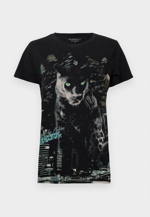 Melna kokvilnas T-krekls ar grafisku dizainu, kurā attēlota pantera ar zaļām acīm un pilsētas silueta detaļām. Īsas piedurknes, apaļa apkakle.