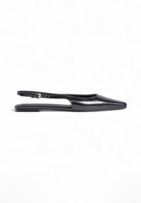 Black leather slingback flats with a pointed toe, open sides, slim ankle strap, and flat sole. Smooth texture with a minimalist design.