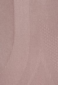 Light pink fabric featuring a mix of ribbed and smooth textures, with subtle patterns and sheen across different sections.