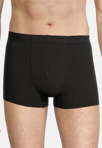 Black cotton boxer shorts with a fitted design, featuring a smooth texture and a contoured pouch. Stitched seams along the edges.