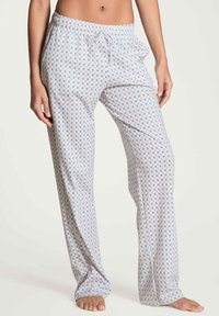 Lichte, gemusterde pyjamabroek in het wit met kleine paarse en blauwe ontwerpen, met een elastische tailleband en een trekkoord.