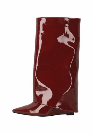 Glossy dark red knee-high boot with a pointed toe and flat sole, smooth shiny finish, standing upright on white background.