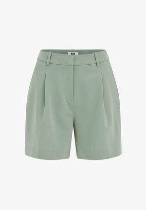 Gaiši zaļas piemērotas šorti ar jostas cilpām, krokām priekšpusē un noslēptu priekšējo aizdari.