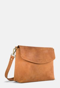 Brown leather messenger bag with a flap closure, adjustable strap, and a smooth texture; embossed logo on the front.