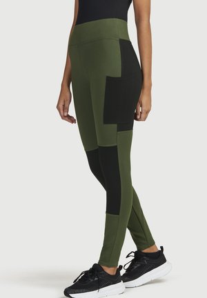 Olive green leggings with black side panels and a large side pocket. Made from stretchy fabric, tailored fit, and a high waistband.
