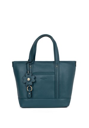 Petrolkleurige leren handtas met dubbele handvaten, een voorvak en een sleutelhanger in de vorm van een bloem die aan één handvat hangt.