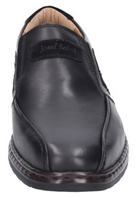Scarpa in pelle nera con punta rotonda, pannelli laterali elasticizzati, colletto imbottito e cuciture dettagliate lungo la suola. Marchio visibile sul lato.