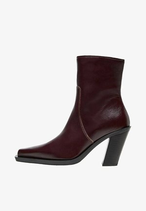 Burgundy leather ankle boot featuring a pointed toe, smooth texture, and a chunky black heel. Stitching detail along the side.