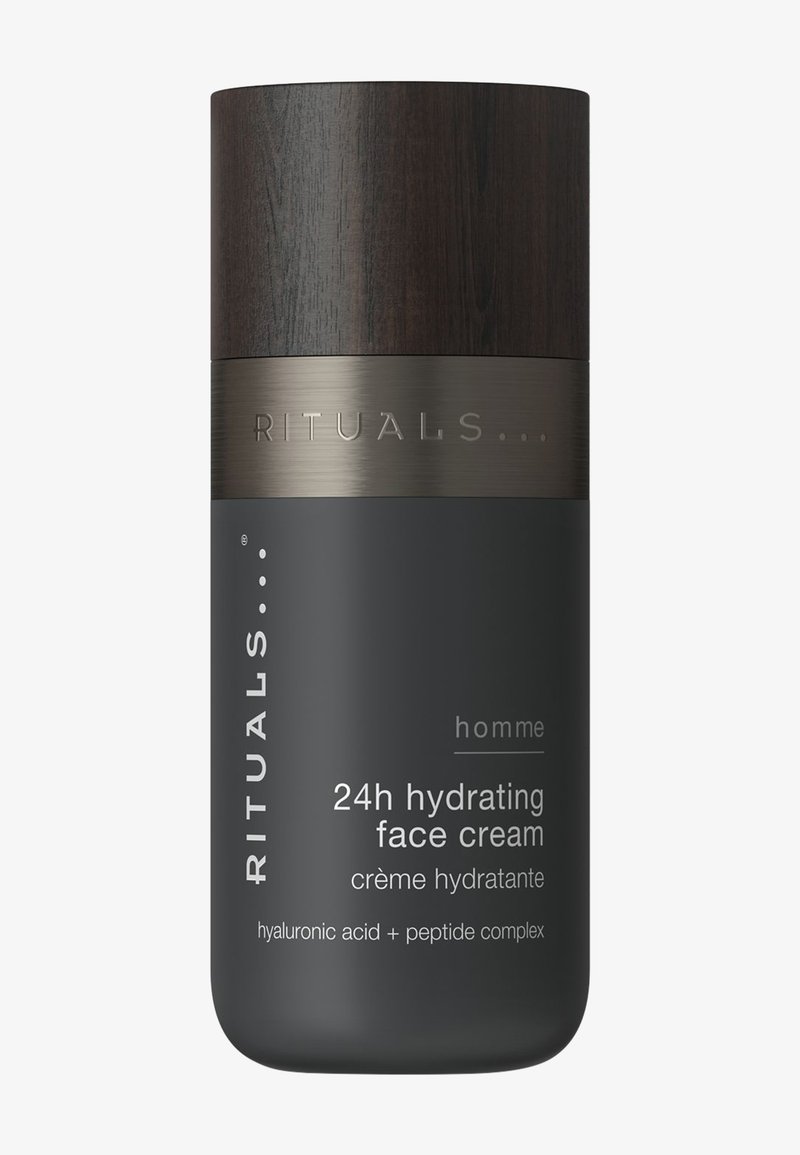 Dark grey cylindrical container with wooden cap labeled "Rituals homme 24h hydrating face cream" with hyaluronic acid and peptide complex.