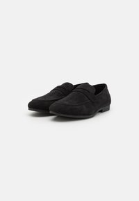 Black suede loafers featuring a sleek design, soft texture, and minimal stitching with a low heel. No visible hardware or accents.